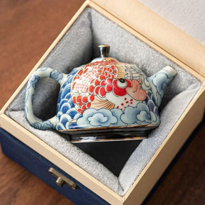 Théière en porcelaine décor sous glaçure avec infuseur