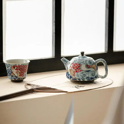Théière en porcelaine décor sous glaçure avec infuseur
